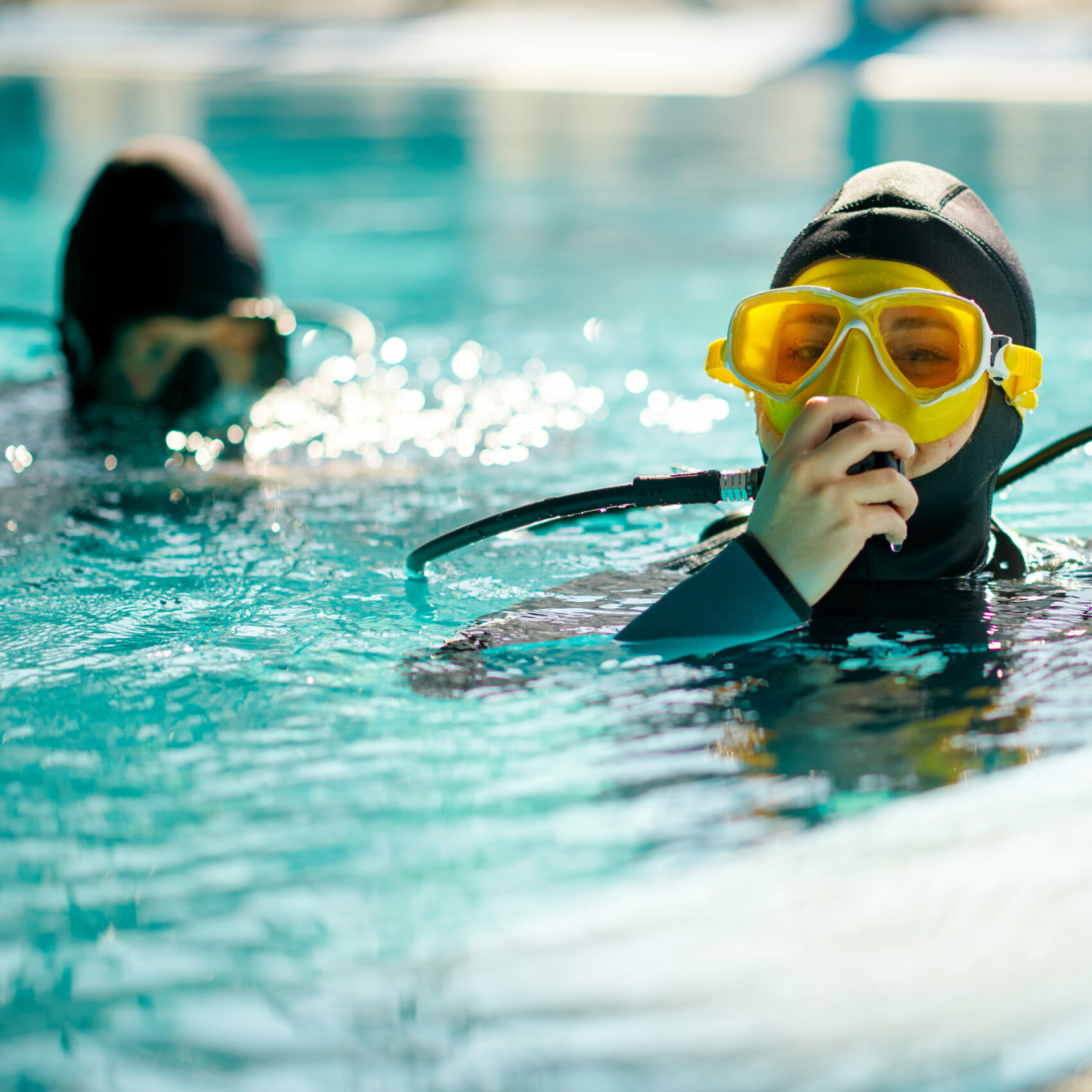 Female diver and male divemaster, dive lesson